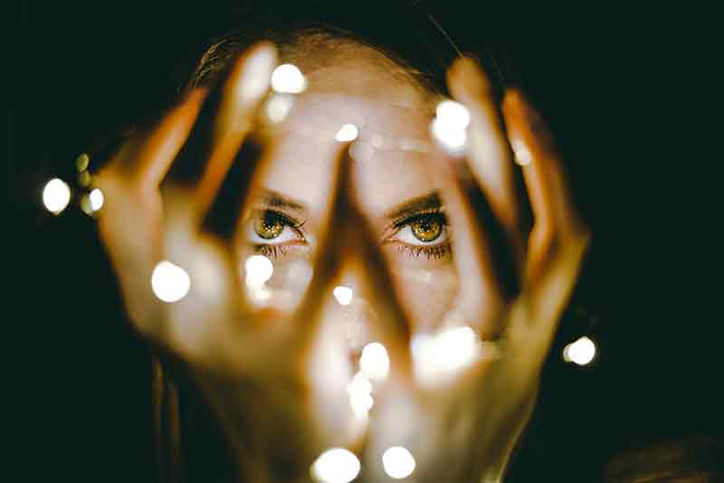 Woman holding a string of lights