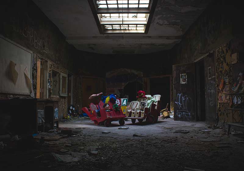 An abandoned room with old toys in it