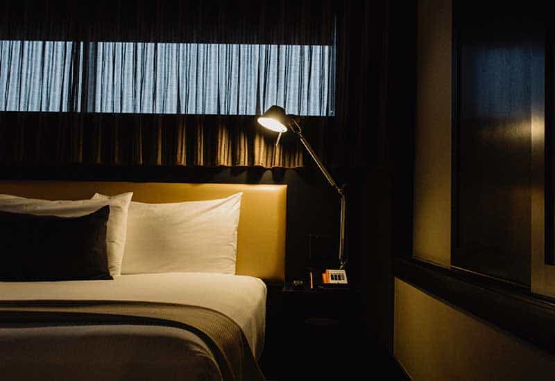 A bed with a reading lamp