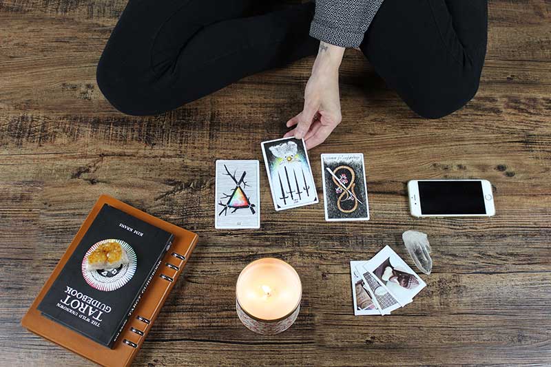 A person laying out tarot cards