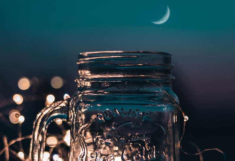 A glass jar with string lights in it