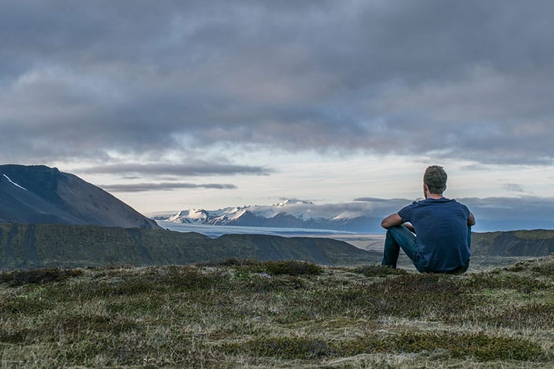 A man sitting on a mountain