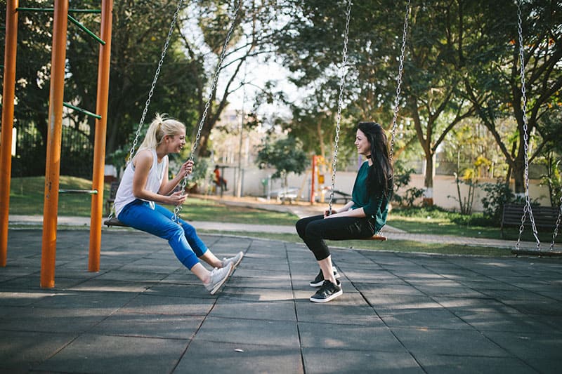 Two woman on a swing